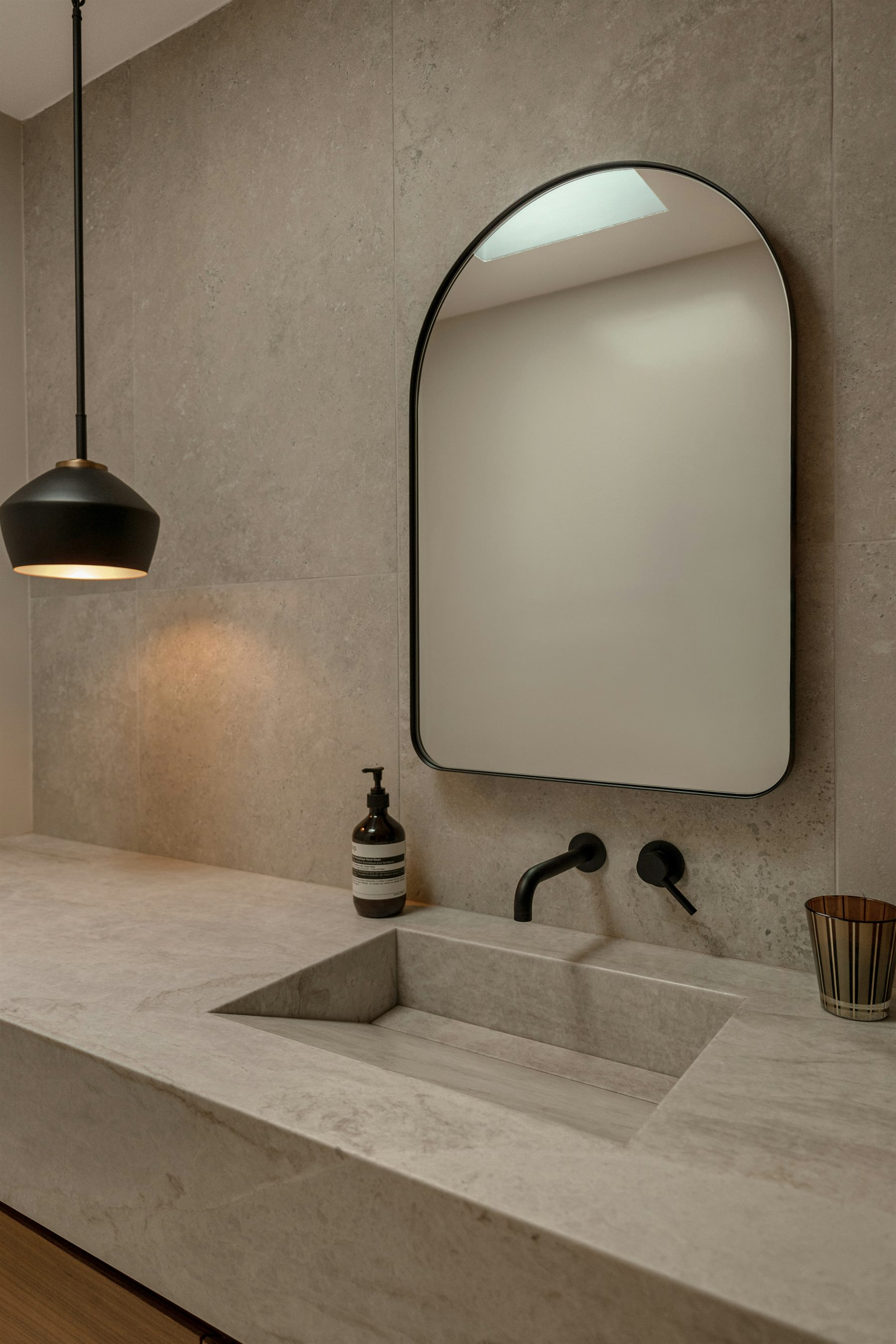 Warm vanity and arch mirror detail